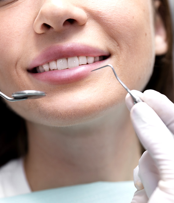 person smiles after dental crowns procedure