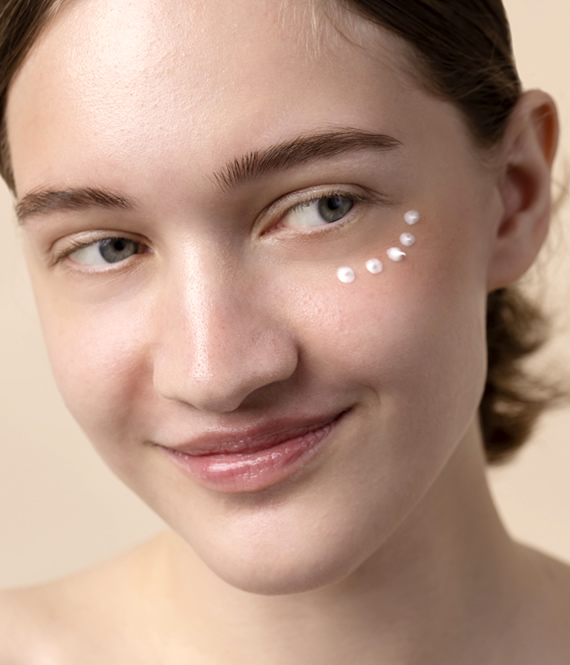 young person using an under eye treatment