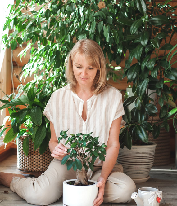 calm woman with indoor plants