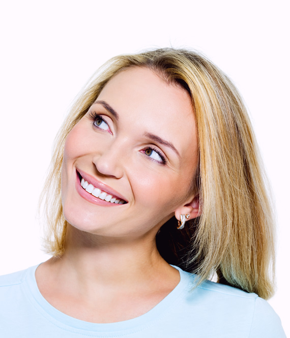 middle aged woman after tooth replacement smiling confident