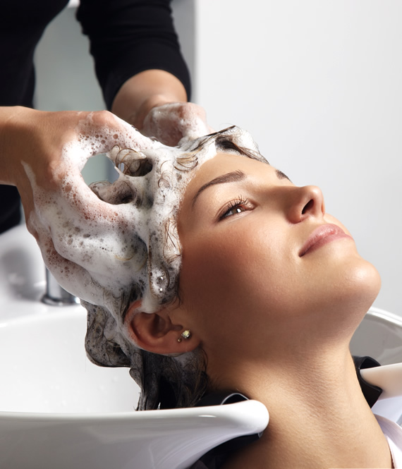 person receives a hair wash treatment at a beauty salon