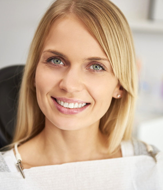 pleased woman after tooth replacement procedure