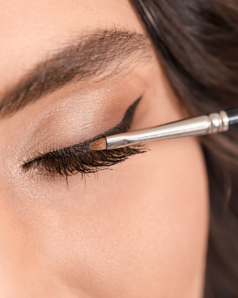 Woman applies gel eyeliner for demonstration